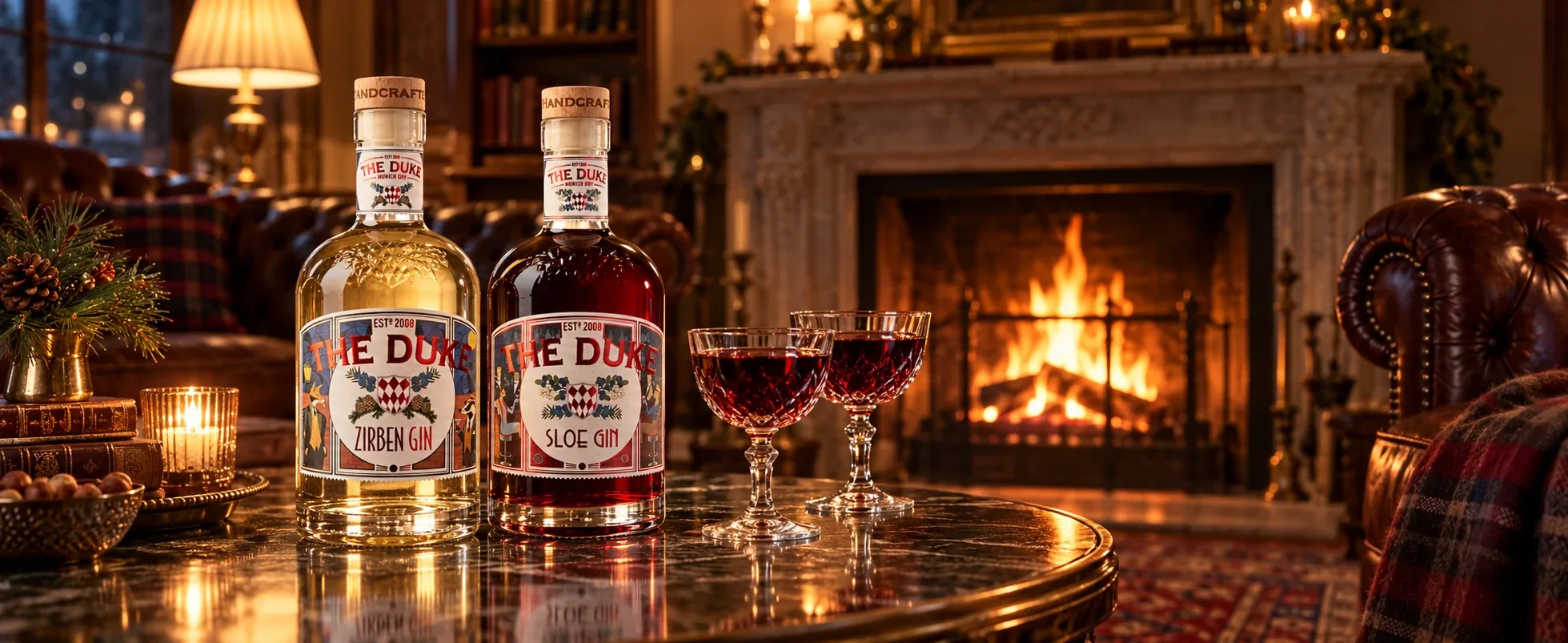 THE DUKE Zirben Gin and Sloe Gin with two glasses on a marble table in front of a crackling fireplace