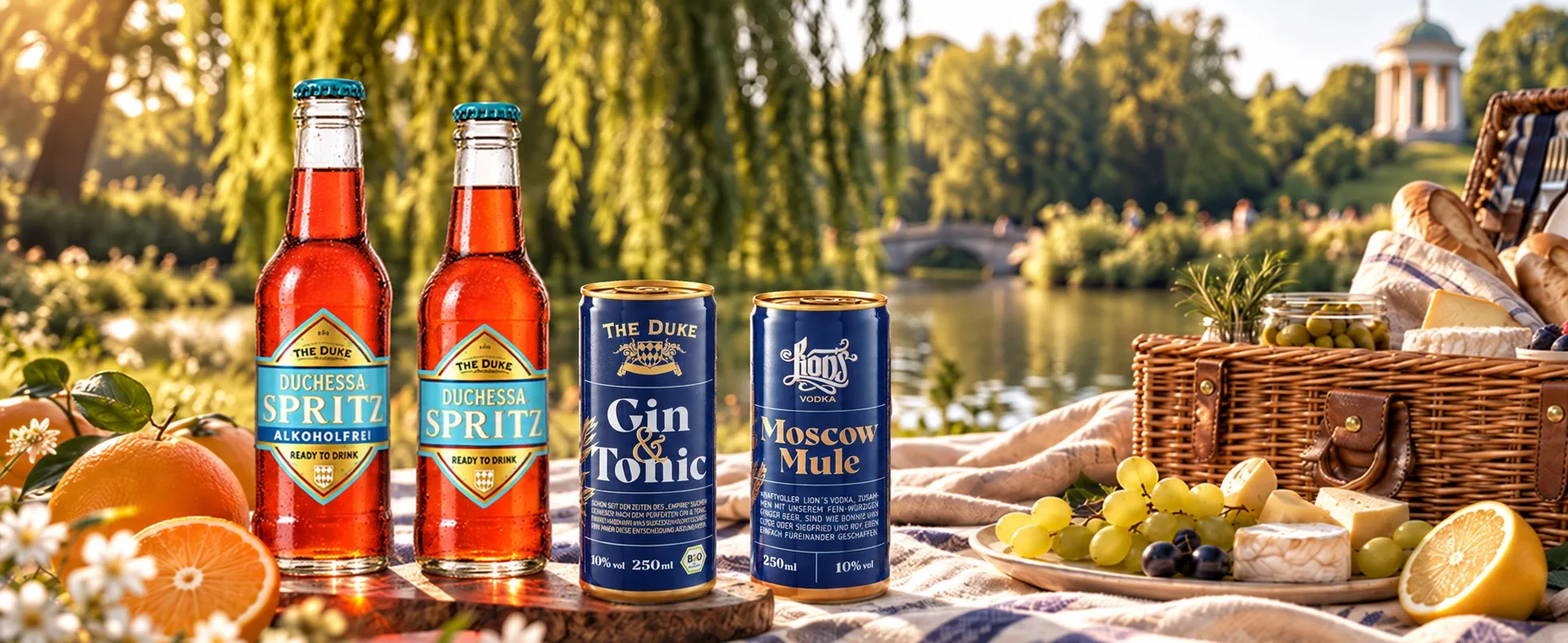 La Duchessa Spritz alcohol-free, La Duchessa Spritz, THE DUKE Gin & Tonic and LION’s Moscow Mule on a picnic blanket by a lake