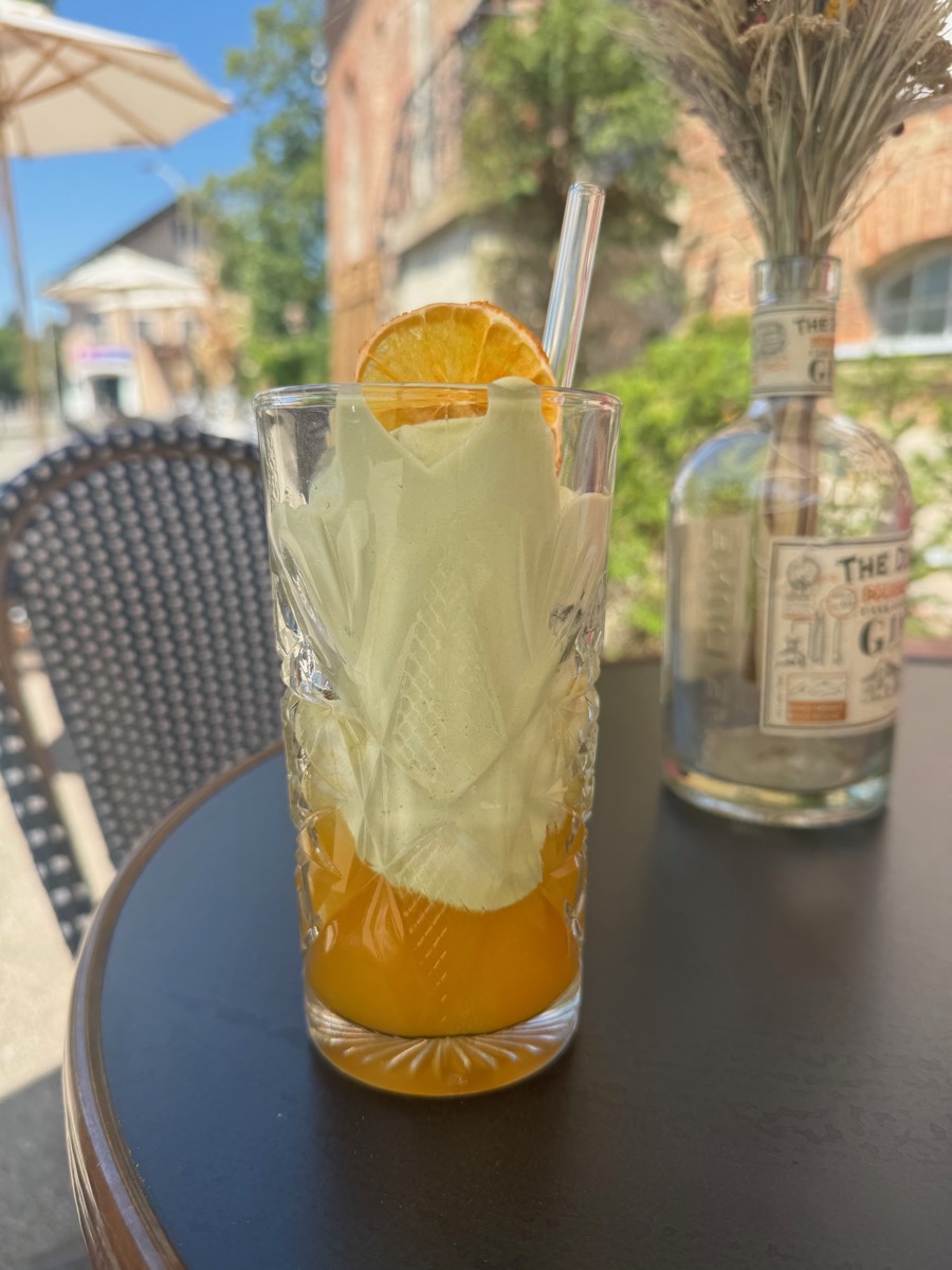 Home-made lemonade with dried orange in a cut glass on the terrace table