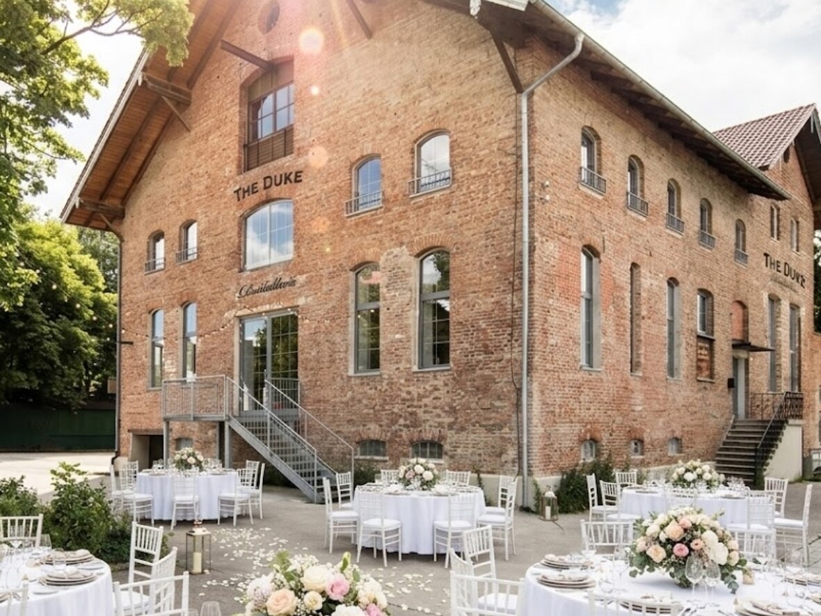 Wedding reception with set tables outside the THE DUKE distillery