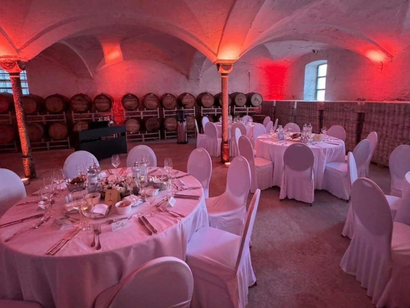 Festively set round table in the vaulted cellar of the THE DUKE distillery